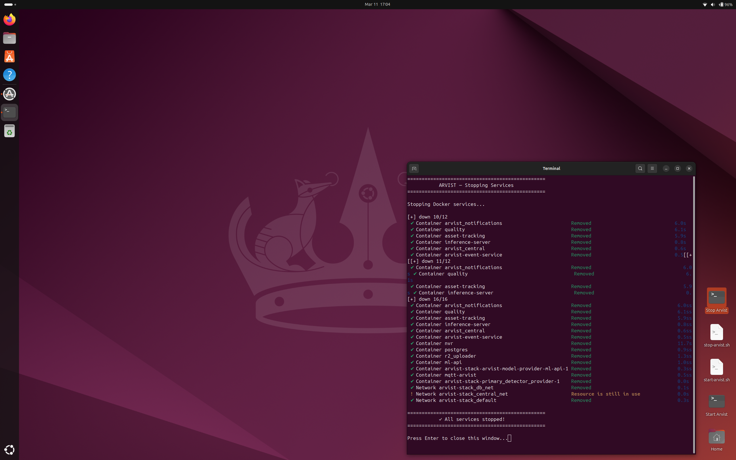 Stop Arvist terminal showing all Docker containers removed with green checkmarks and "All services stopped!" confirmation